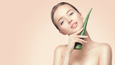 Beauty,Woman,With,Perfect,Skin,Holding,Fresh,Leaf,Of,Aloe
