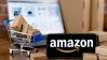 Smartphone con logo de Amazon en pantalla, carrito de compras y laptop por su Big Spring Sale 2024.